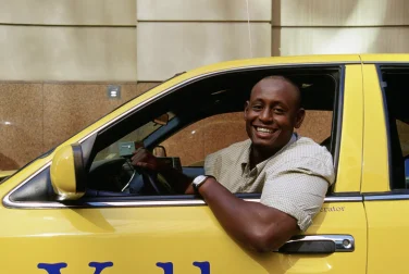 cab-driver-leaning-out-of-his-yellow-cab-1